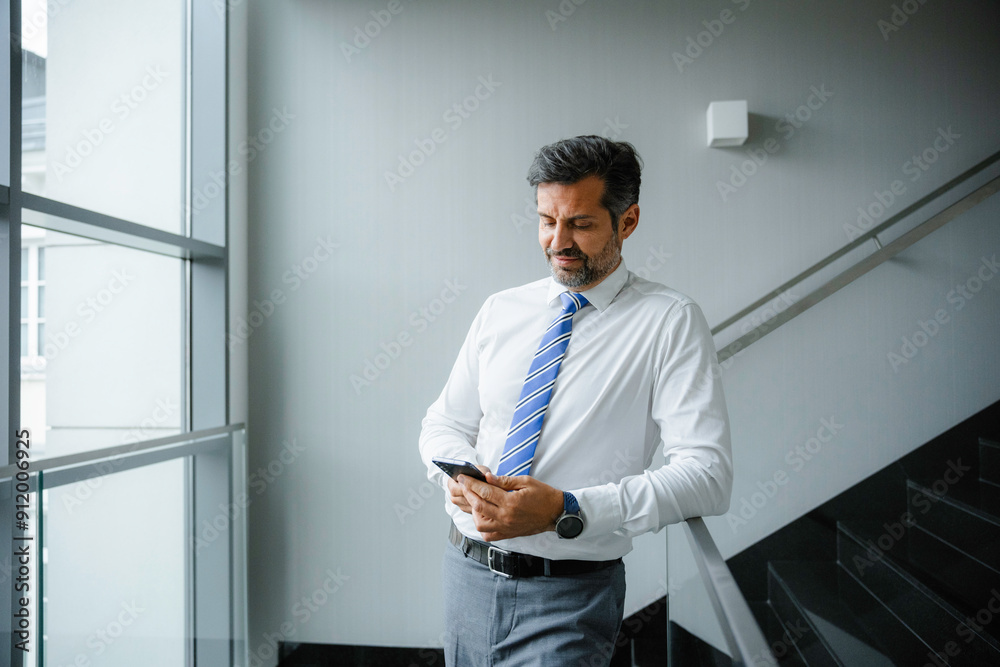 A man uses a mobile phone A man uses a mobile phone