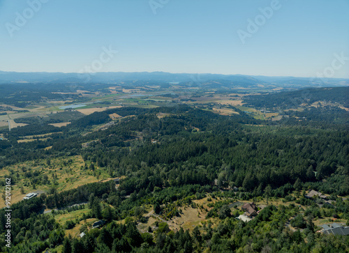 A beautiful view of a forest with a house in the distance