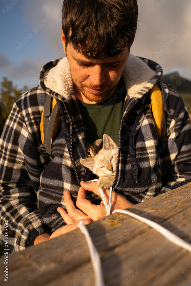 Man taking care of kittens in nature Man taking care of kittens in nature