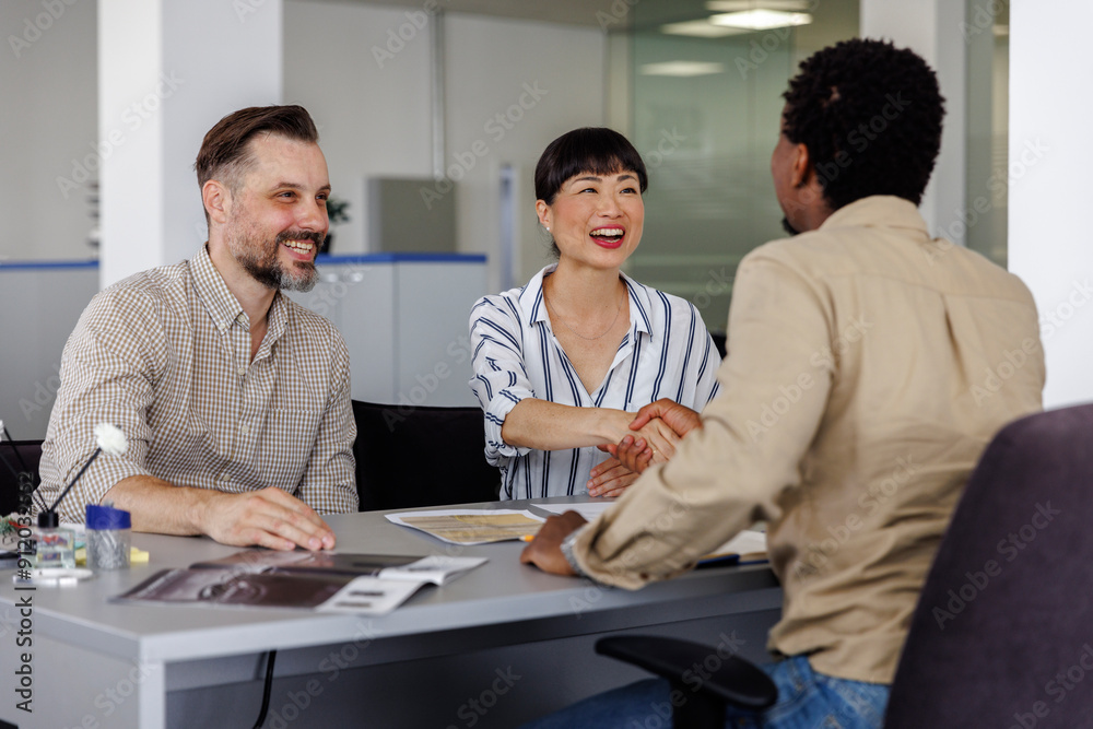 Happy businesswoman handshaking with colleague in meeting Happy businesswoman handshaking with colleague in meeting