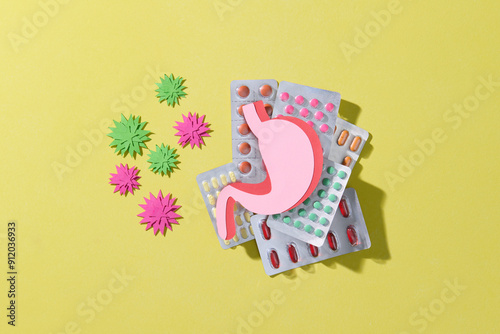 Stomach Health Concept with Pills, virus on Yellow Background