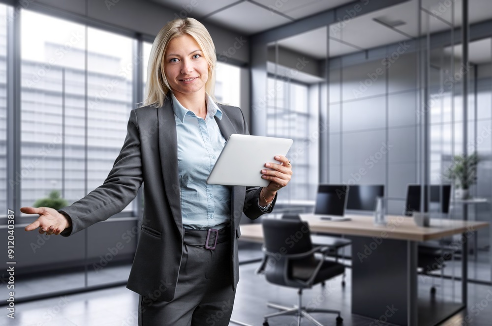 Happy female office worker using digital tablet Happy female office worker using digital tablet