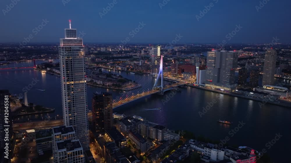 Lively charm of Rotterdam at twilight from above, highlighting the glowing erasmus bridge, contemporary buildings, and peaceful canals