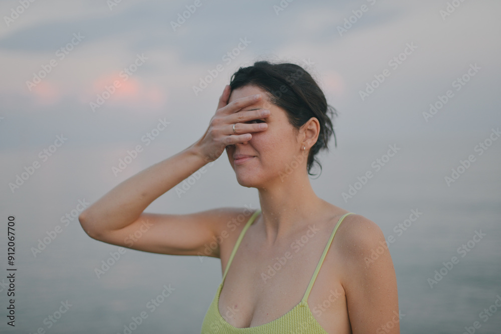 A woman closing her face in a sea A woman closing her face in a sea