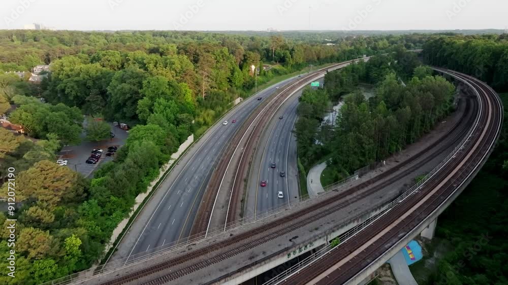 Aerial view of Buckhead Atlanta subway station rail tracks, road driving through natural trails and parks, Georgia State Route 400 Aerial view of Buckhead Atlanta subway station rail tracks, road driving through natural trails and parks, Georgia State Route 400