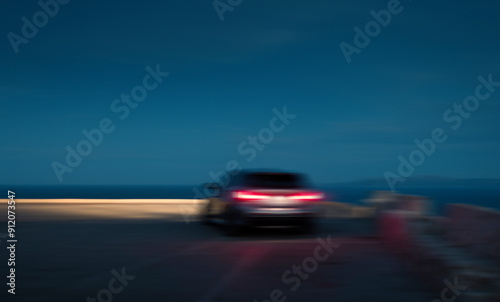 Blurred car in movement at sunset