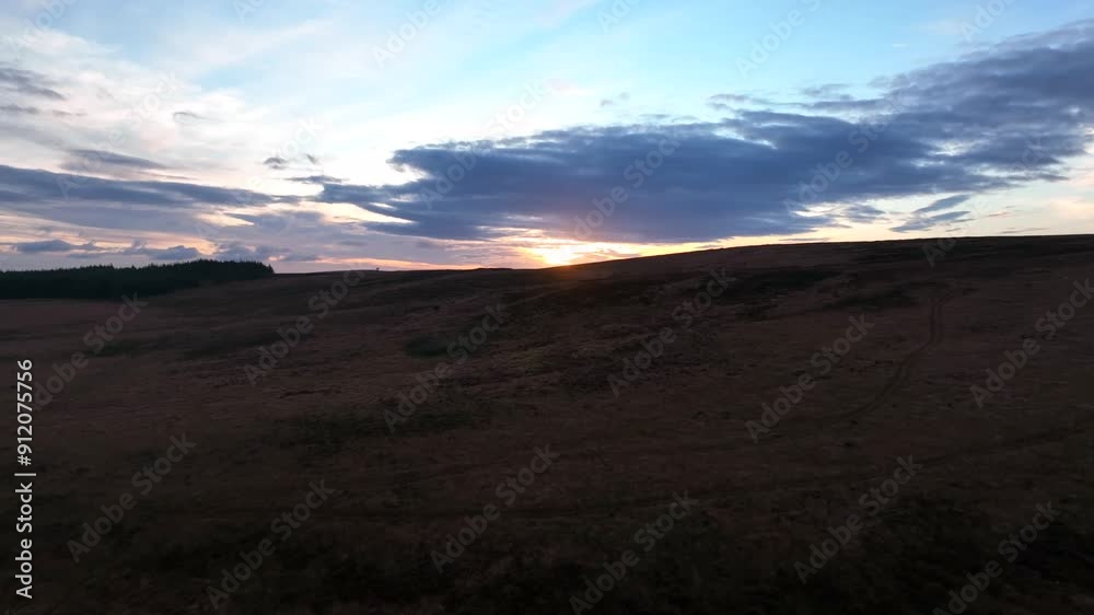 Sliabh Beagh, County Monaghan, Ireland, November 2022. Drone pushes west over the rugged peat bogs ascending to reveal the winter sunset over Eshbrack with Lough Aportan in the distance. Sliabh Beagh, County Monaghan, Ireland, November 2022. Drone pushes west over the rugged peat bogs ascending to reveal the winter sunset over Eshbrack with Lough Aportan in the distance.