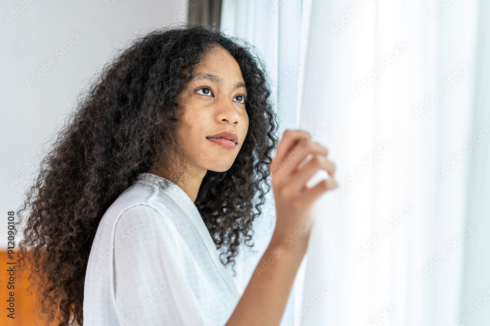 Portrait of beautiful young adult caucasian and African American women wake up in morning break with freshness and standing near the window and opening white curtains. Portrait of beautiful young adult caucasian and African American women wake up in morning break with freshness and standing near the window and opening white curtains.