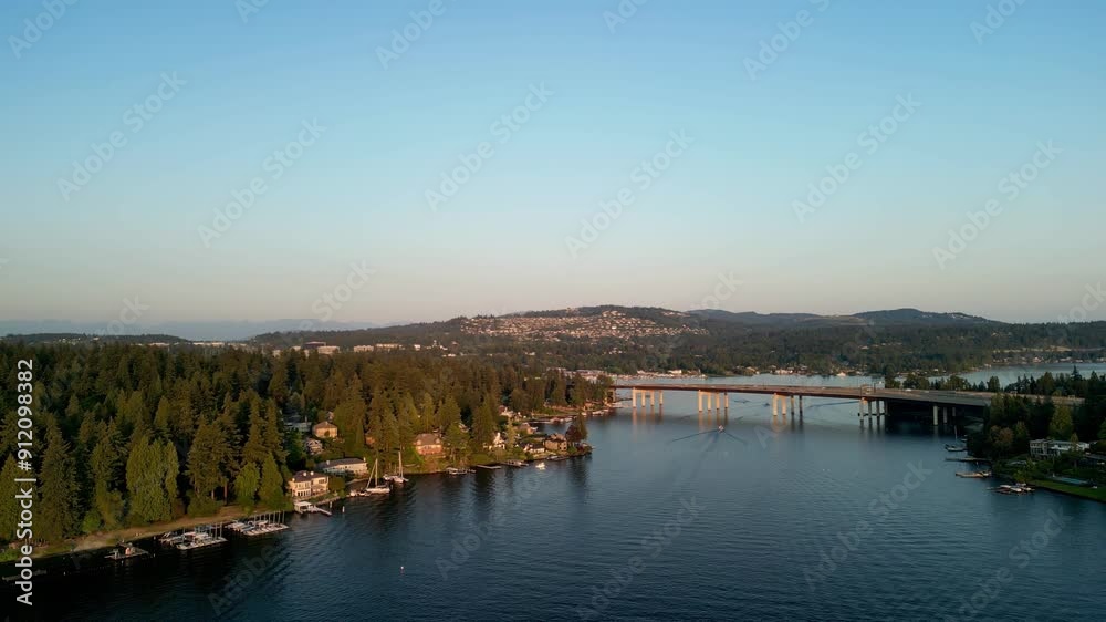 Aerial View of Bridge Over Lake Surrounded by Forested Hills and Residential Areas in Seattle Area at Sunset Aerial View of Bridge Over Lake Surrounded by Forested Hills and Residential Areas in Seattle Area at Sunset