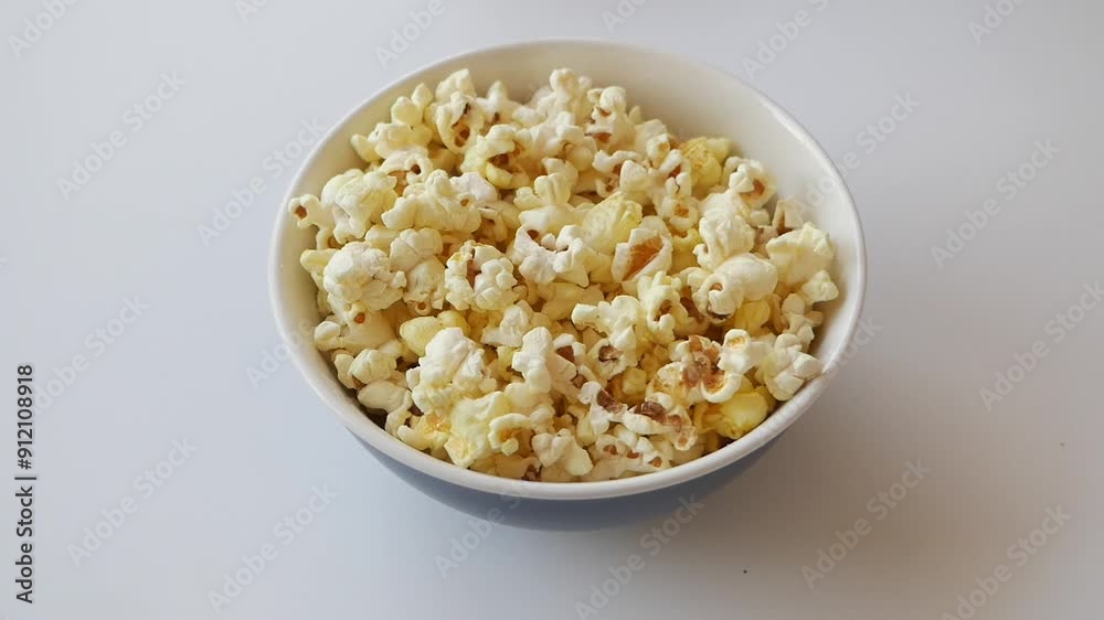 top view of child hand pick popcorn on white background top view of child hand pick popcorn on white background