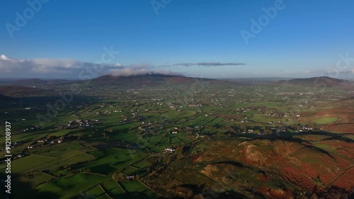 Flagstaff, County Down, Northern Ireland, November 2022. Drone pushes west over rural farmland with the Ring of Gullion in the distance during a warm winter morning. photo