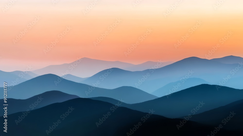 Fototapeta premium A panoramic view of a majestic mountain range during sunset with layers of colors in the sky and a serene valley below capturing the aweinspiring beauty of the natural landscape