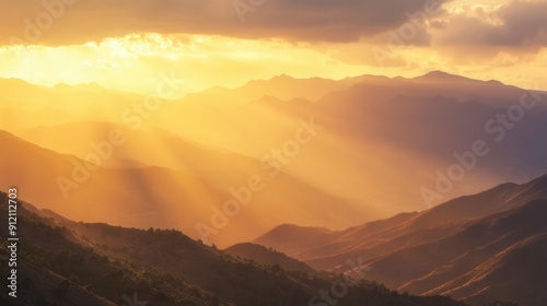 Sun illuminating mountain ridges with golden light creating a stunning panoramic view of the rugged terrain