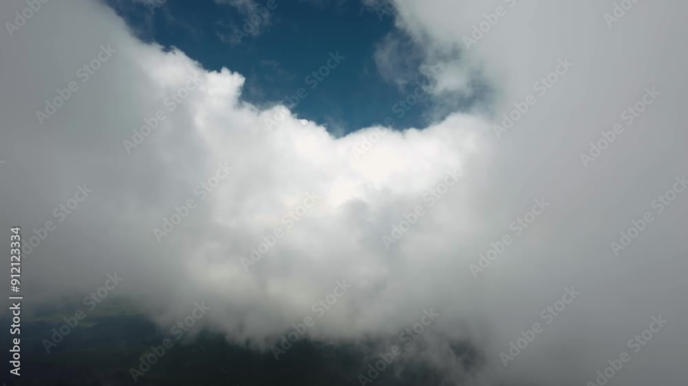 Flying on a plane through fluffy, snow-white clouds. Breathtaking view from the plane window. The plane flies into a cluster of beautiful clouds Flying on a plane through fluffy, snow-white clouds. Breathtaking view from the plane window. The plane flies into a cluster of beautiful clouds