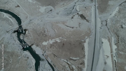 Frozen road and river in Iceland in Winter in a remote and barren landscape 4K photo