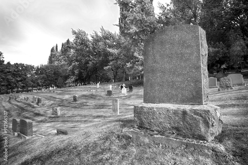 Large blank tombstone in cemetery.