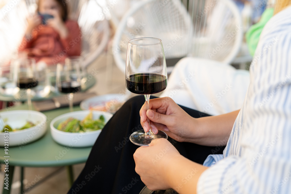 Woman drinking red wine at dinner table Woman drinking red wine at dinner table