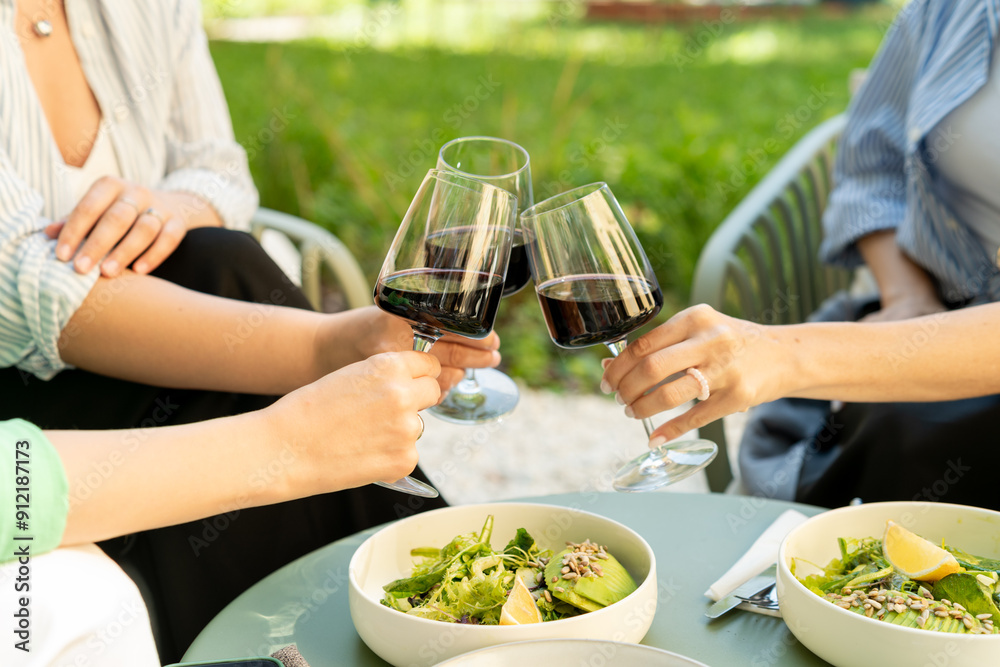 Overhead view of friends having brunch, toasting, saying cheers holding ...