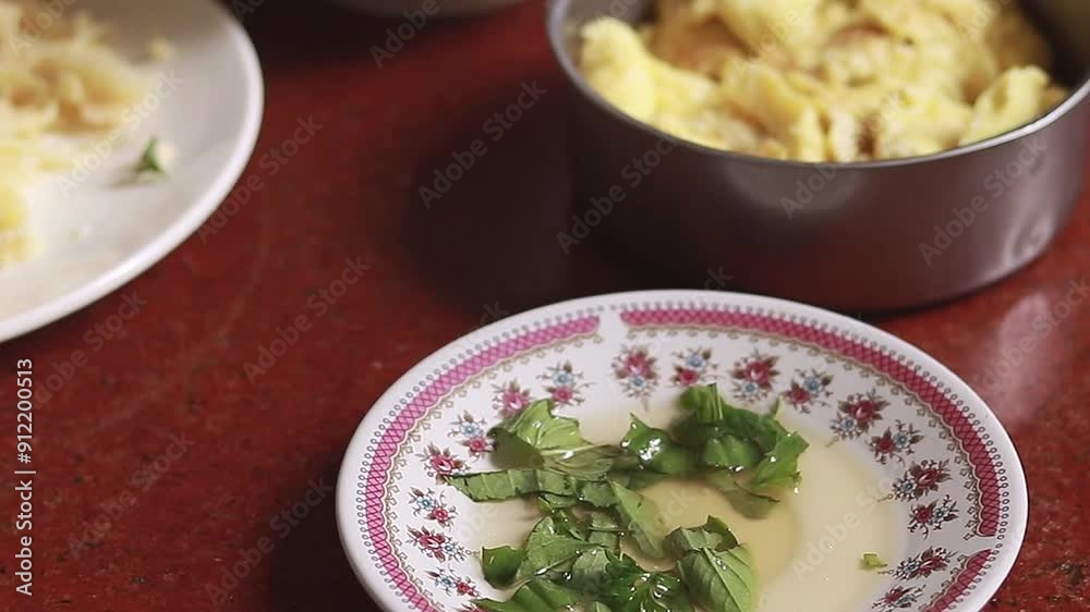 A piece of lumpia or the iconic local filipino fried spring rolls being dipped in a saucer of vinegar with chopped herbs A piece of lumpia or the iconic local filipino fried spring rolls being dipped in a saucer of vinegar with chopped herbs