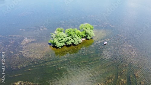 Pewaukee Lake In Waukesha County, Wisconsin; Aerial Drone Tilt Up From A Small Islet To The Main Village And Lakefront Park. photo