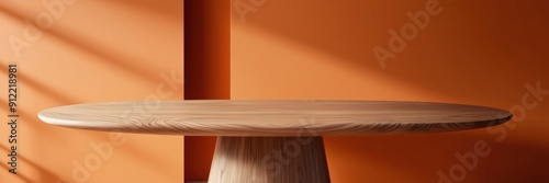 High-quality image of a smooth wooden table in a sunlit room with an orange wall, showcasing minimalist interior design.