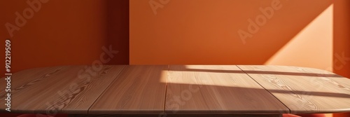 High-quality image of a smooth wooden table in a sunlit room with an orange wall, showcasing minimalist interior design.