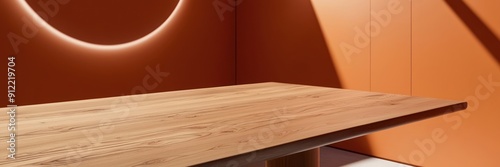 High-quality image of a smooth wooden table in a sunlit room with an orange wall, showcasing minimalist interior design.