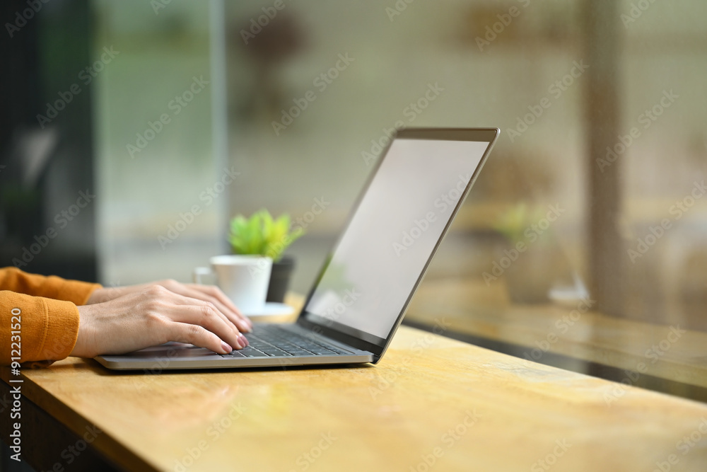 Closeup shot oof an unrecognizable woman hands typing on laptop keyboard, working remotely at cafe Closeup shot oof an unrecognizable woman hands typing on laptop keyboard, working remotely at cafe
