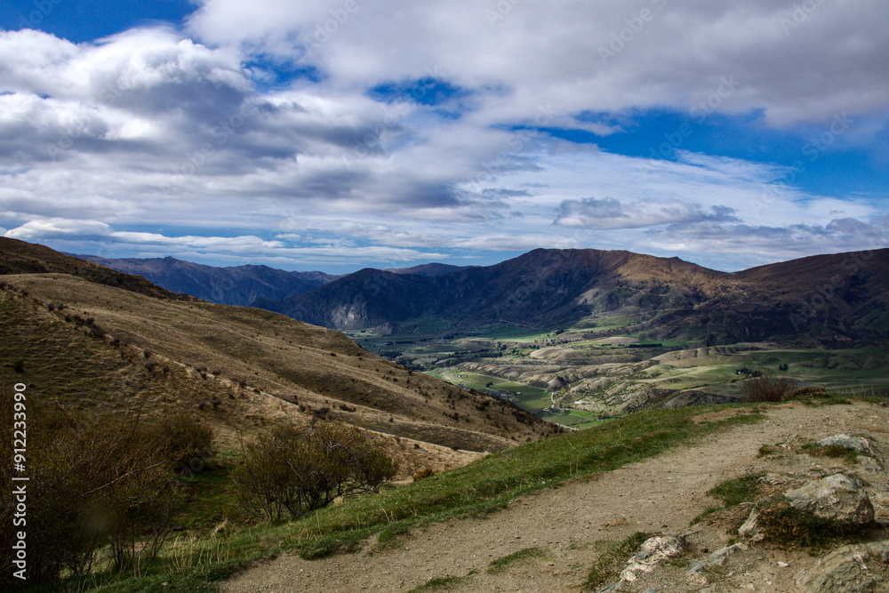 Fototapeta premium Lookout from Queenstown to Wannika overlooking a valley on a windy day in New Zealand