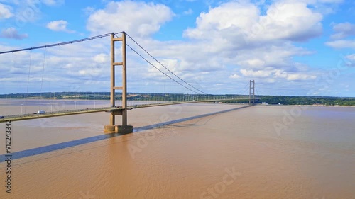 Aerial drone view of Humber Bridge, 12th largest suspension span, gracefully crossing River Humber, connecting Lincolnshire to Humberside with traffic.
