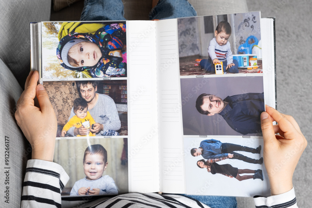 © Zarina Lukash - Woman looking at family photo album about her family. © Zarina Lukash - Woman looking at family photo album about her family.