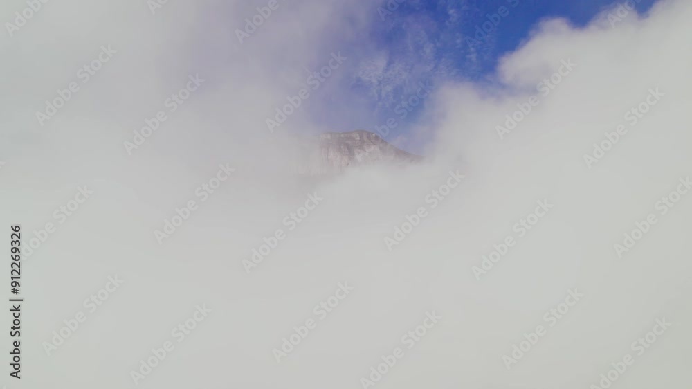 Flying between clouds in reverse and the orbital view of a mountain Flying between clouds in reverse and the orbital view of a mountain