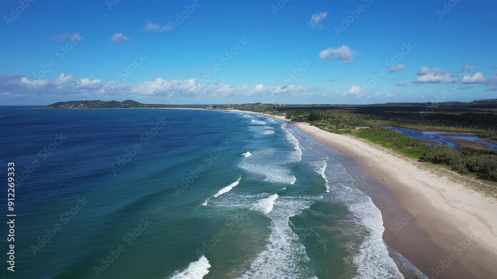 Splashing Waves On The Sandy Shore Of Belongil Beach, Byron Bay, New South Wales, Australia - Aerial Drone Shot Splashing Waves On The Sandy Shore Of Belongil Beach, Byron Bay, New South Wales, Australia - Aerial Drone Shot