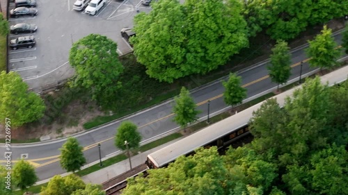 Drone shot of Atlanta metro rail crossing through Georgia State Route 400, T Harvey Mathis Parkway photo