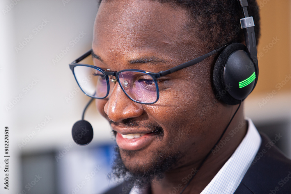 Naklejka premium Friendly man african american wearing with headset worker call center working customer support operator using computer at office. Business online customer service center.