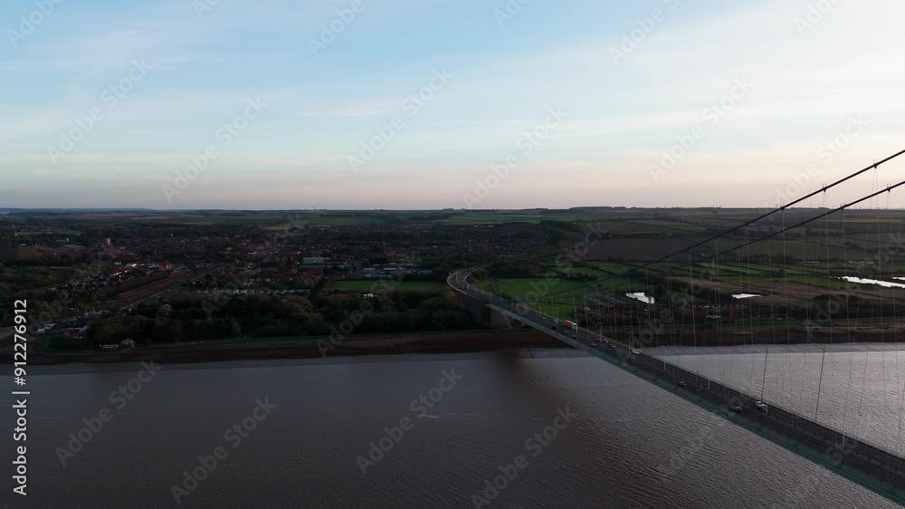Humber Bridge at dusk, cars navigating gently under the setting sun. Humber Bridge at dusk, cars navigating gently under the setting sun.