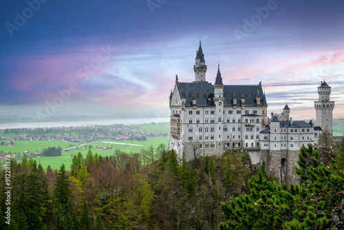 Golden hour casts a magical glow on ancient stone fortress perched atop a hill, a breathtaking European landmark