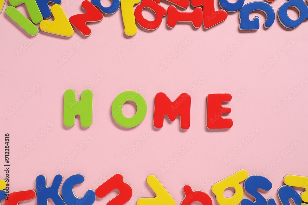 Word Home made of magnetic letters on pink background, flat lay. Learning alphabet Word Home made of magnetic letters on pink background, flat lay. Learning alphabet