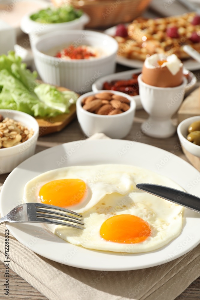 Different meals served for breakfast on wooden table Different meals served for breakfast on wooden table