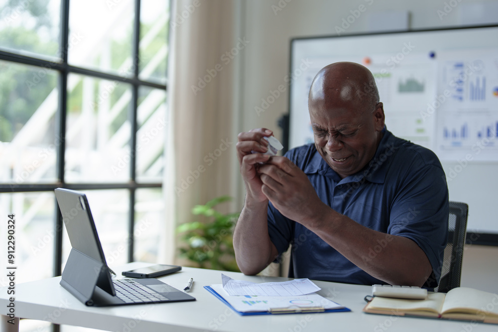 Naklejka premium African American adult businessman upset. Depression. Senior man working in office with paperwork. Dissatisfied with the financial results of an investment malfunction Office syndrome concept.