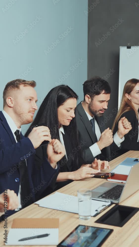 Vertical screen: Employees dance at table during break at business meeting. Concept of workplace fun, team bonding, and stress relief Vertical screen: Employees dance at table during break at business meeting. Concept of workplace fun, team bonding, and stress relief
