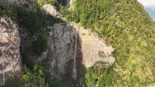 Cascades Against Steep Rock Walls, Seerenbach Falls In Betlis, Amden, Switzerland. Aerial Wide Shot photo