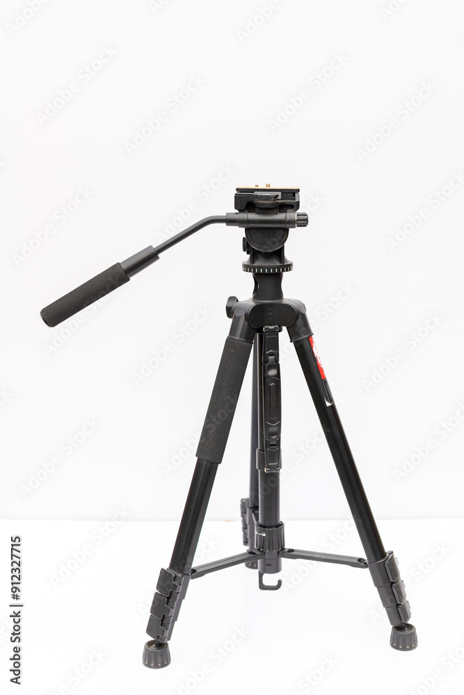 Black professional tripod for camera and smart phone isolated on white background Black professional tripod for camera and smart phone isolated on white background