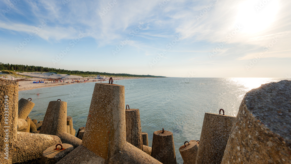 View of the western beach in Leba. Concrete breakwaters in the foreground. Beautiful sunny day. Leba, Poland