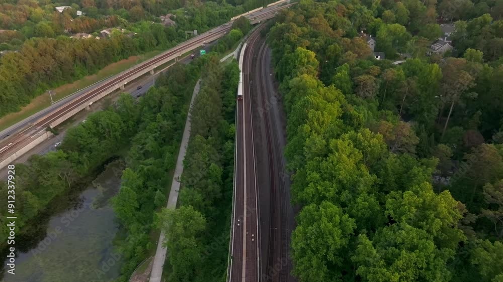 Drone shot of Atlanta metro rail crossing through natural park trails of Buckhead neighbourhood, Georgia State Route 400, T Harvey Mathis Parkway Drone shot of Atlanta metro rail crossing through natural park trails of Buckhead neighbourhood, Georgia State Route 400, T Harvey Mathis Parkway