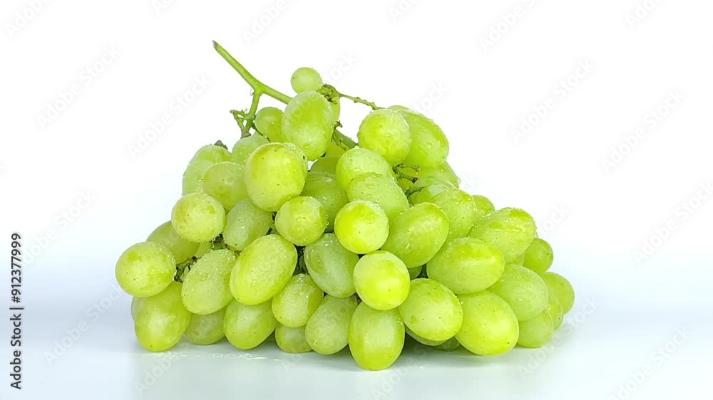 Isolated grapes bunch. Green or yellow grapes with leaves isolated on white background. A bunch of grapes is falling Isolated grapes bunch. Green or yellow grapes with leaves isolated on white background. A bunch of grapes is falling