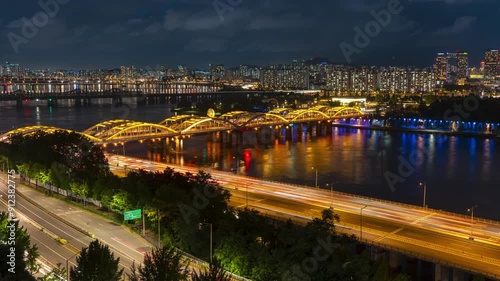 Night Seoul Timelapse of Cars Movement on Olympic Expressway and Hangang Bridge Over Han River, Yongsan District Apartments - slow tilt up photo