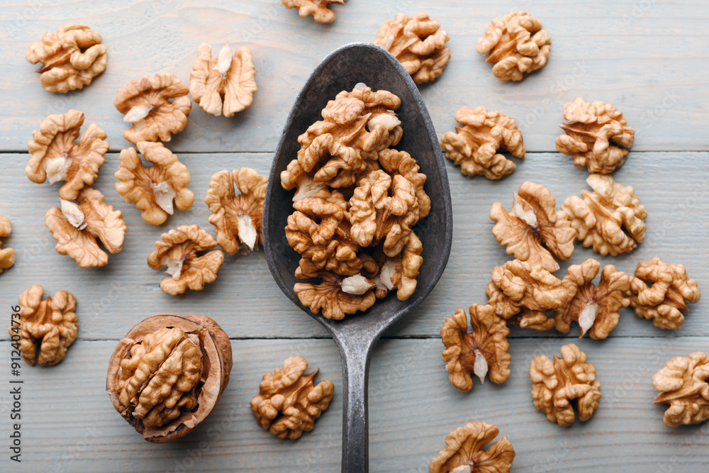 Old spoon with walnut kernels on wooden table close up. Food photography Old spoon with walnut kernels on wooden table close up. Food photography