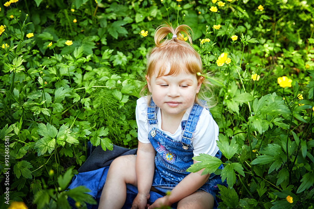 A cute pretty little girl meditates in nature. Toddler enjoys the peace and quiet. Ecology, care A cute pretty little girl meditates in nature. Toddler enjoys the peace and quiet. Ecology, care