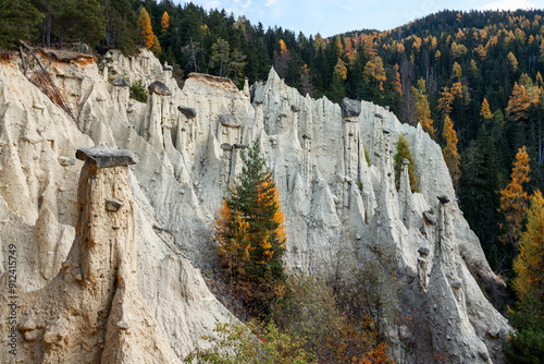 Autumn landscape with natural earth pyramids or stone mushrooms in Dolomite mountains. Renon, Ritten, Dolomites, South Tyrol, Italy photo